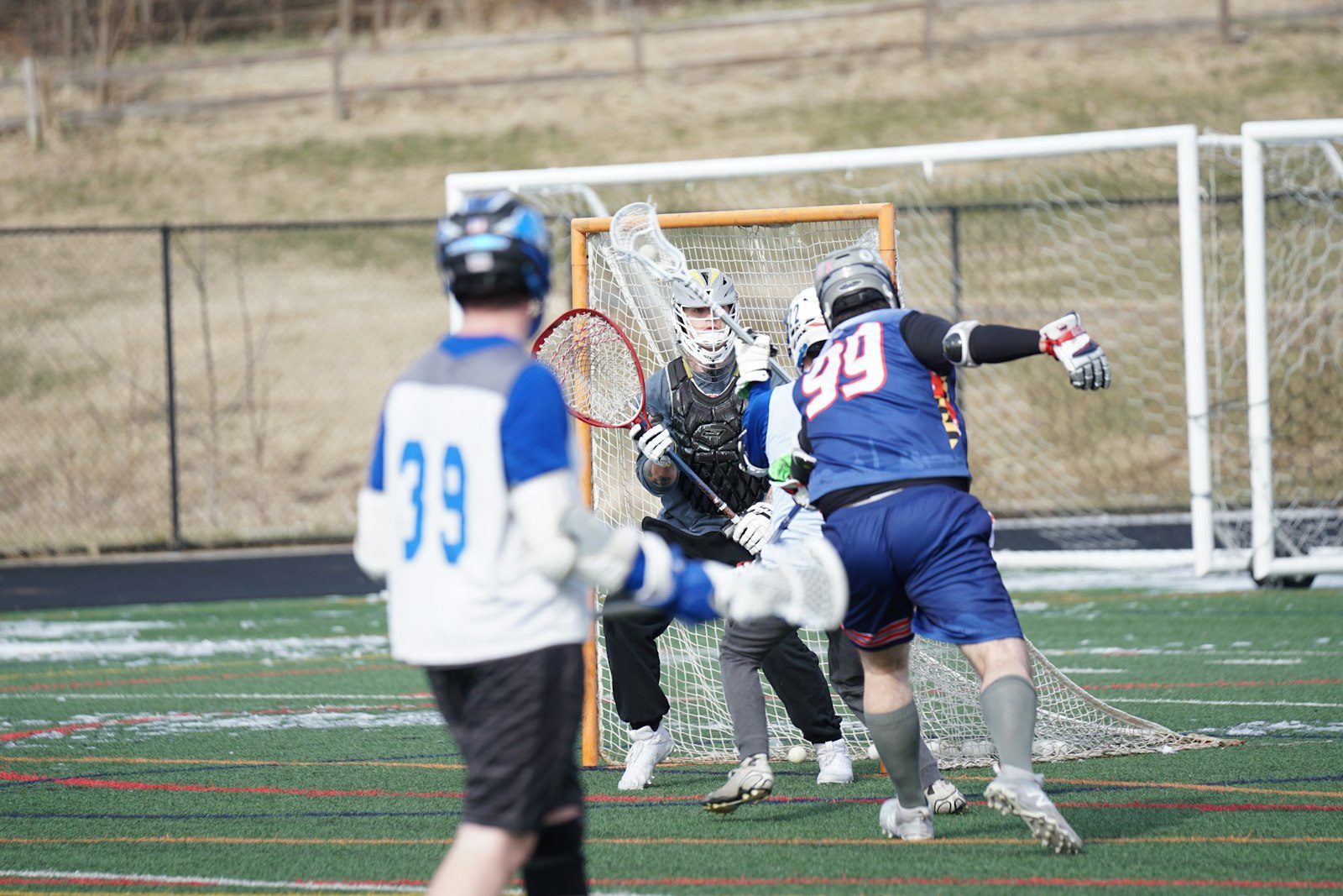 Boys lacrosse players in a scrimmage