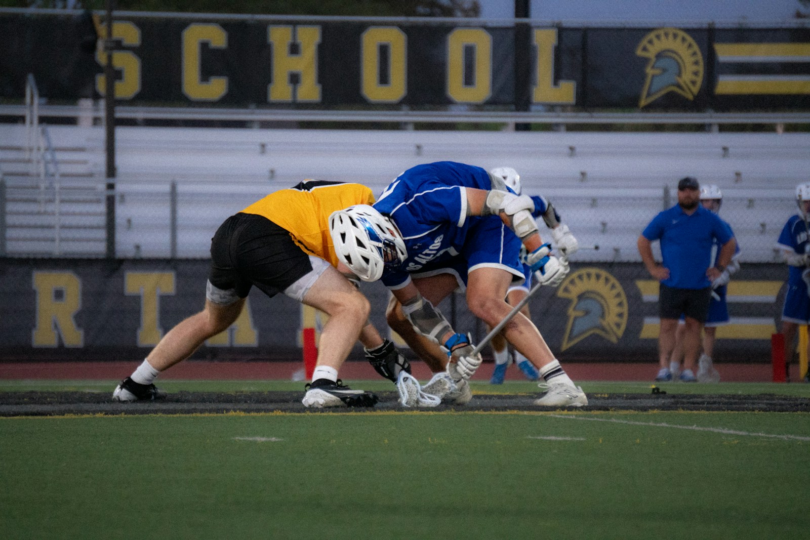 Players battling for the ball in a lacrosse game