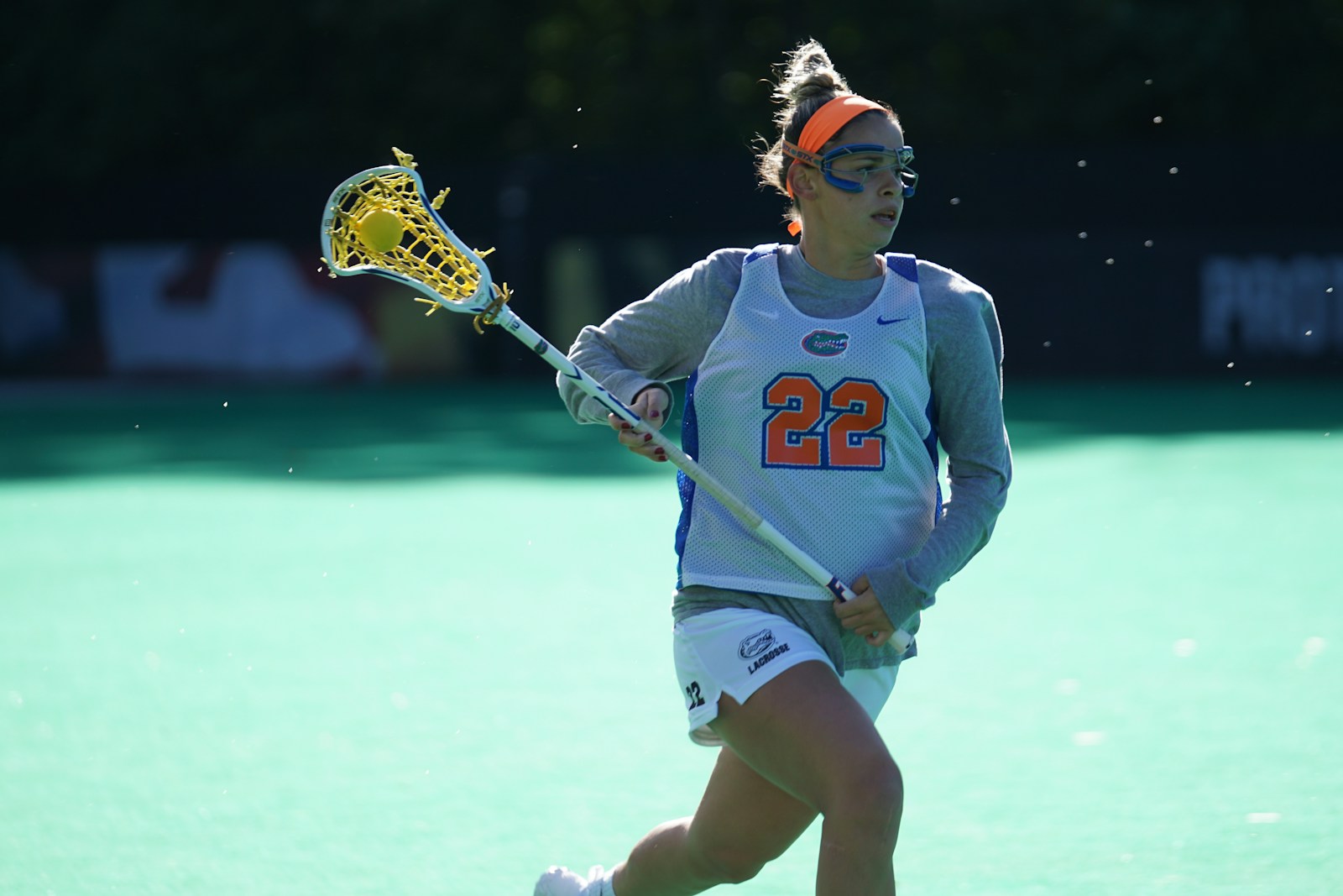 Girls lacrosse player driving to goal